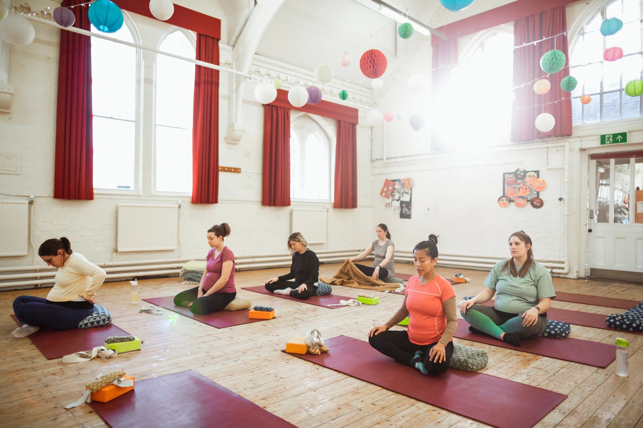 Women in a calm wellness class setting