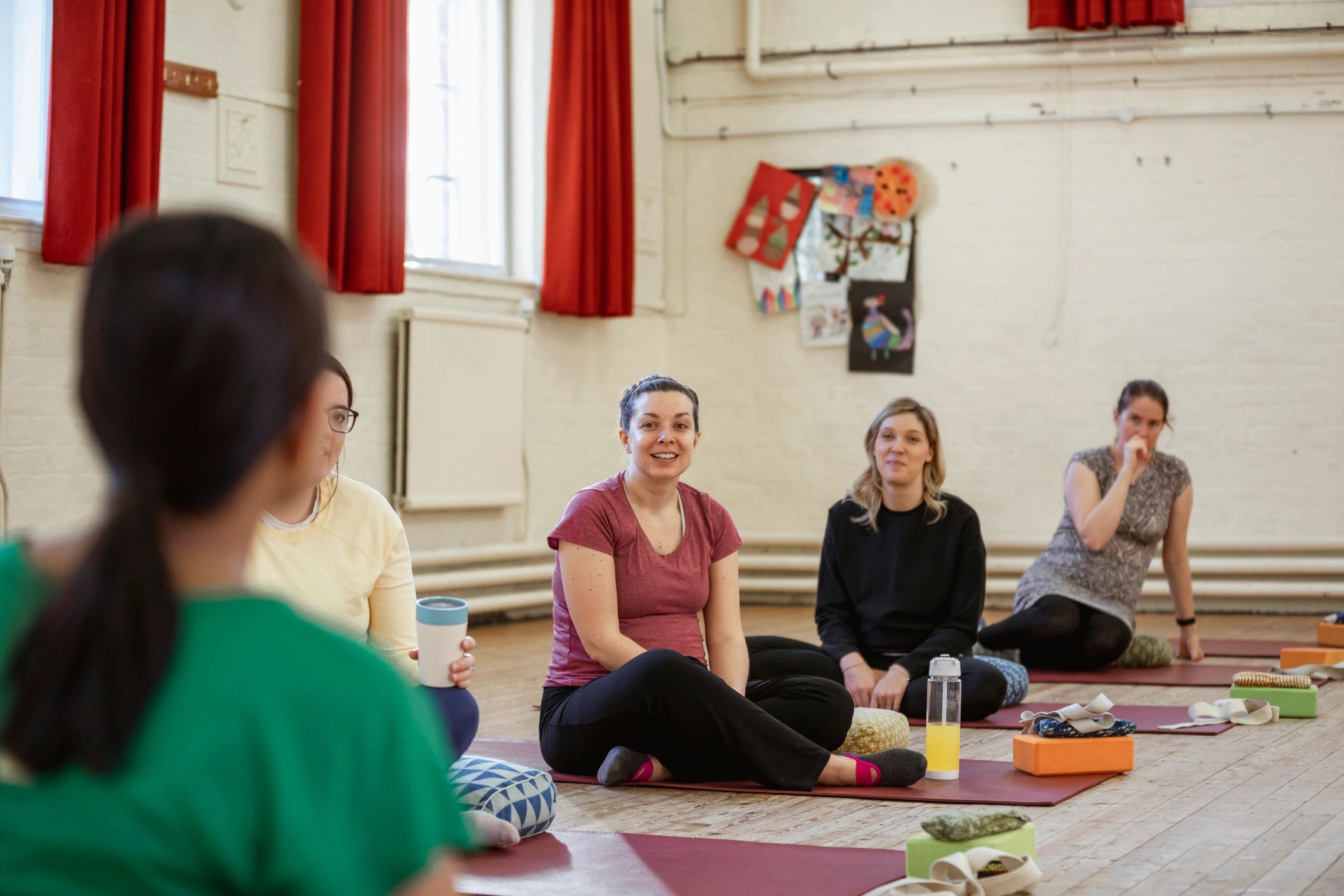 Women in a calm studio setting after class