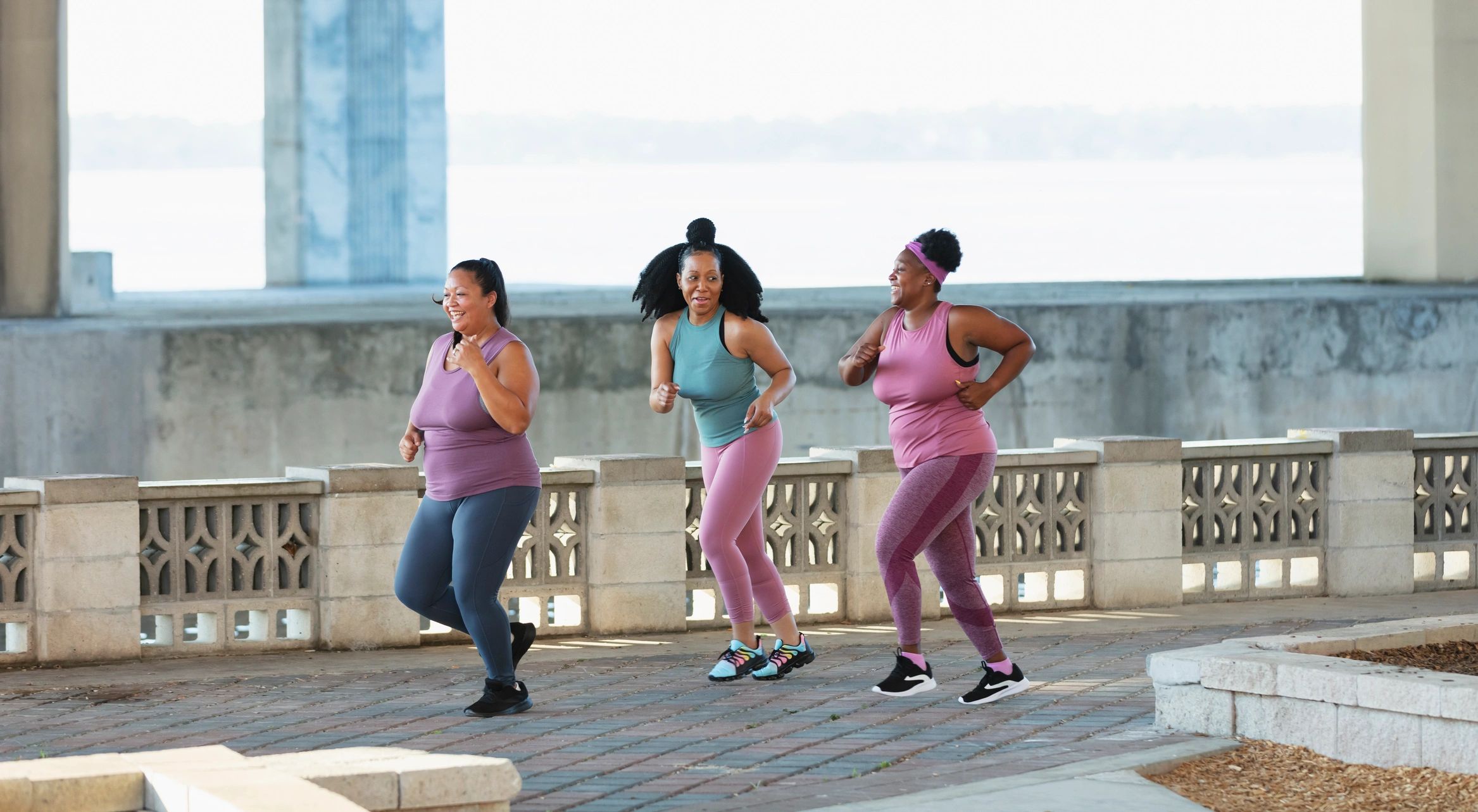 Women running along a city waterfront