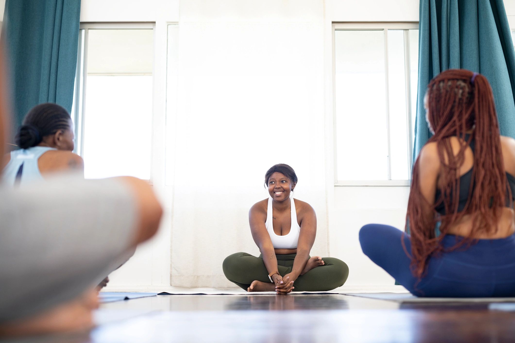 Instructor speaking with women in a studio class